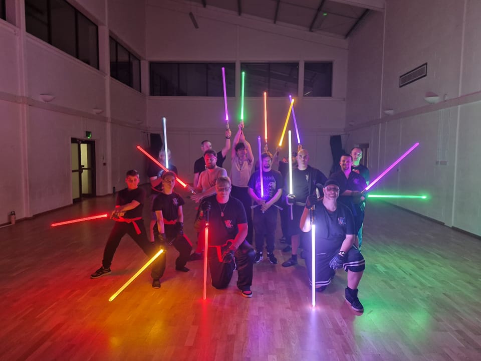Two LED saber practitioners facing each other in training